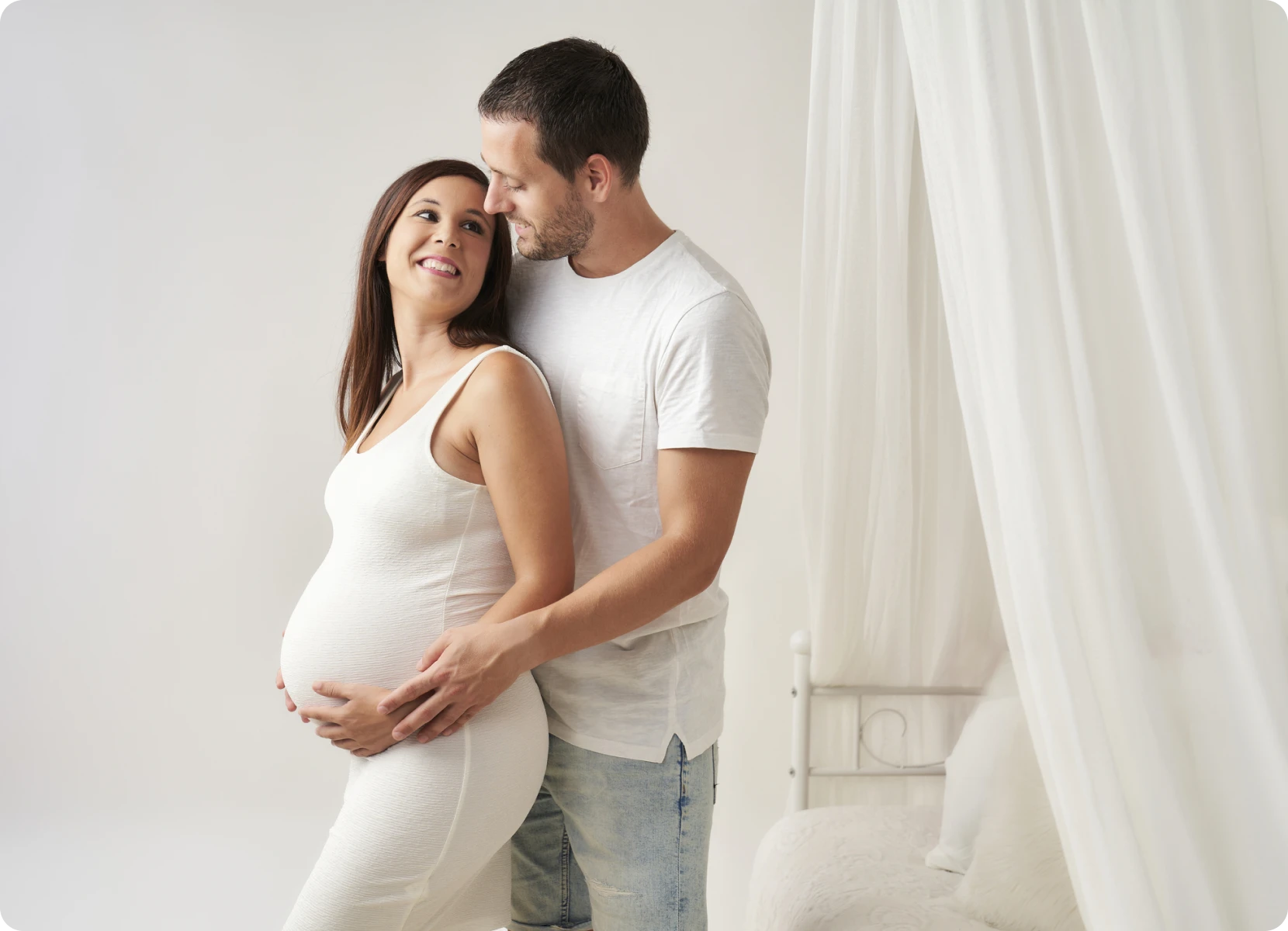 Expecting parents in white attire