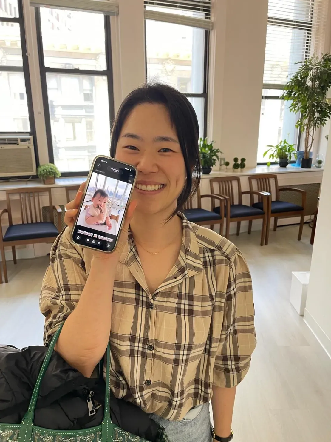 Smiling woman in plaid shirt indoors