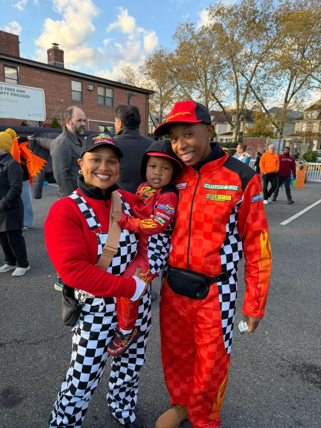 Smiling family dressed as race car drivers