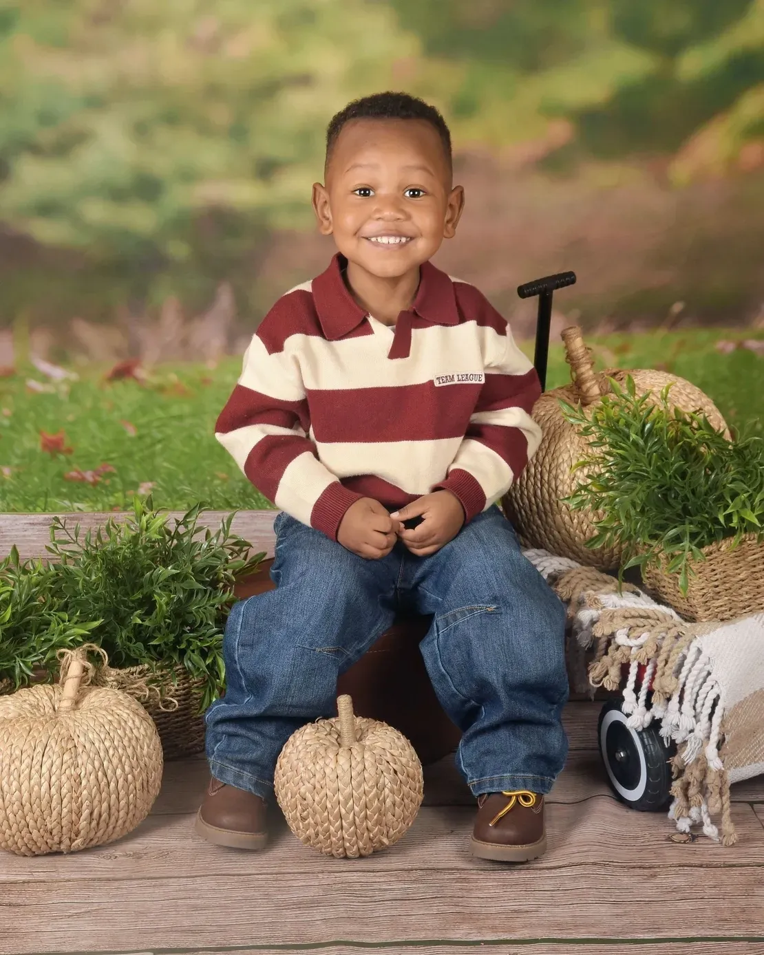 Happy boy in striped sweater outdoors