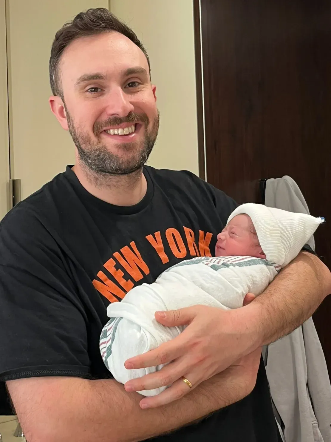Proud father cradles newborn