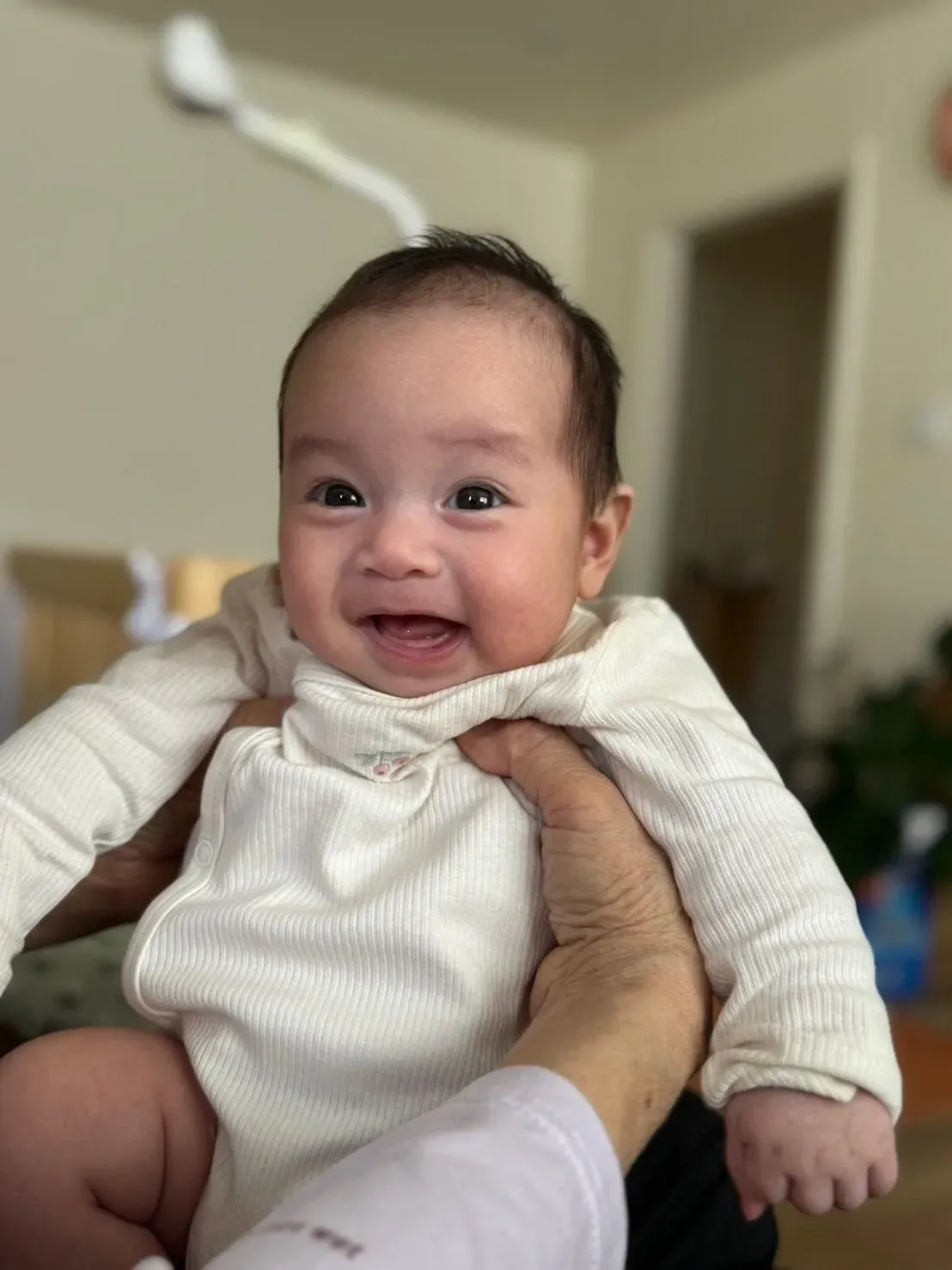 Baby laughing in cozy indoor setting