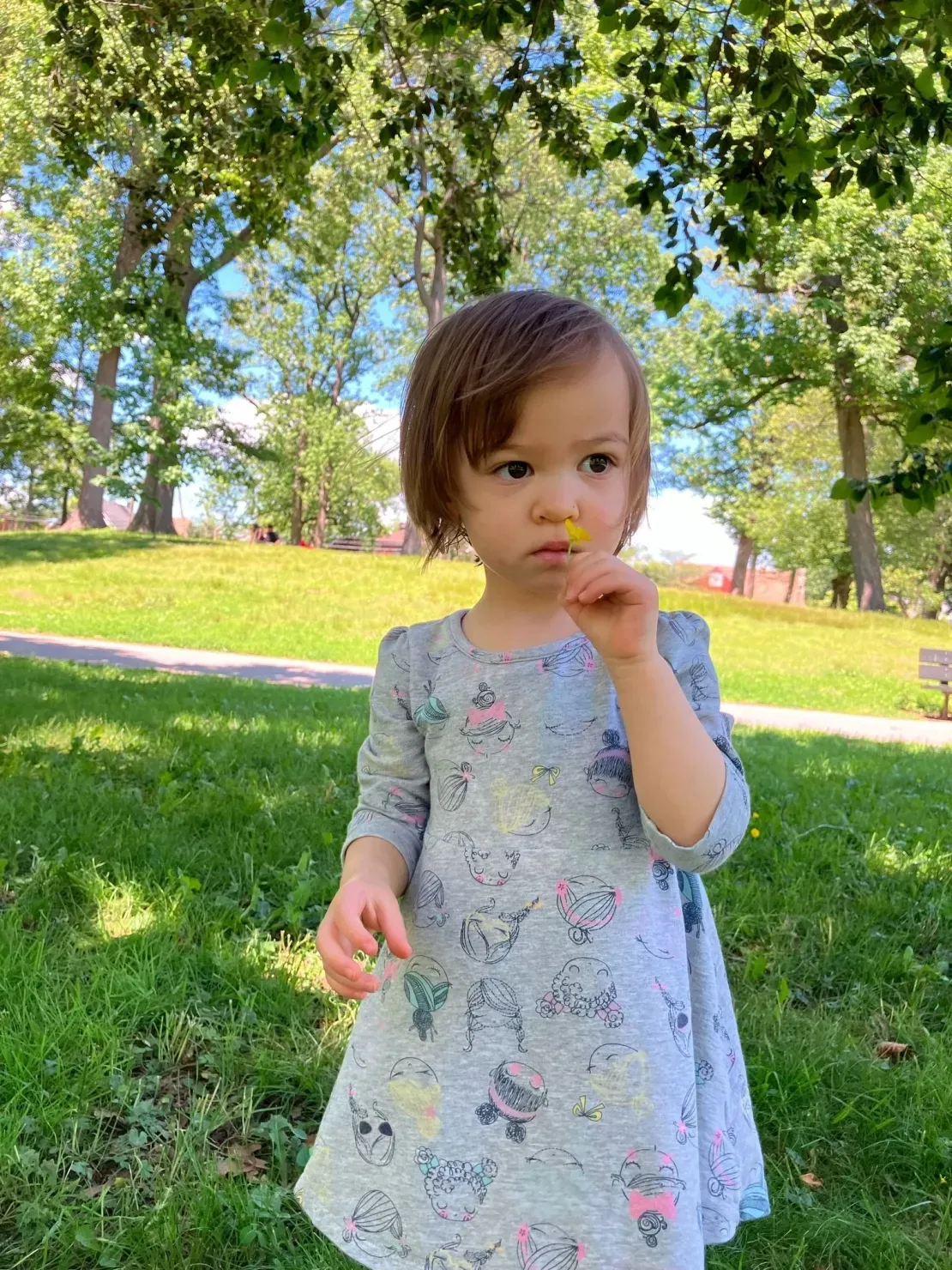 Toddler in gray dress with flower