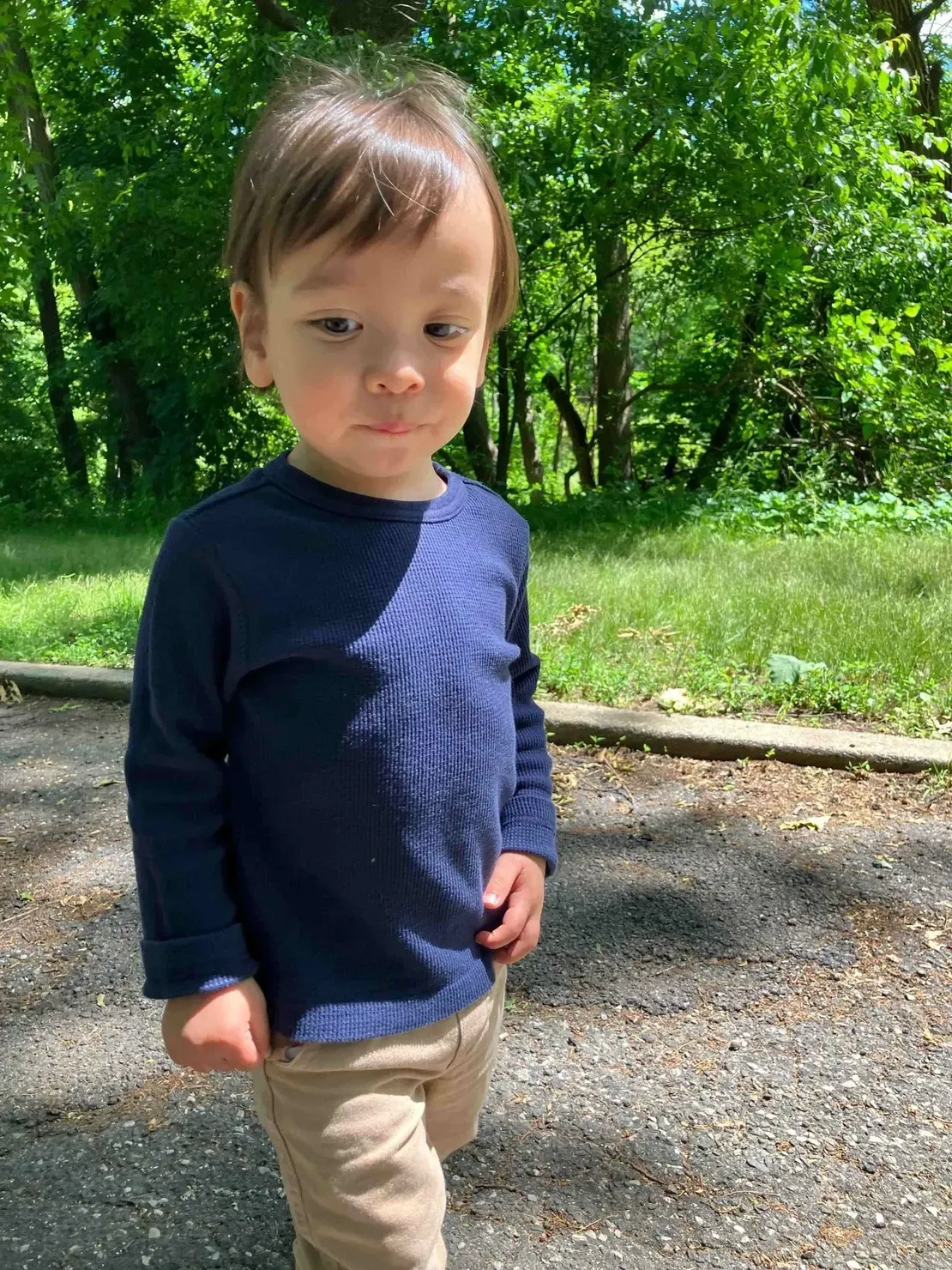 Child in blue shirt outdoors