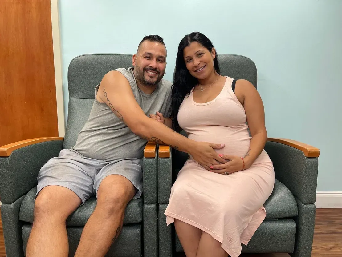 Smiling couple with a baby bump
