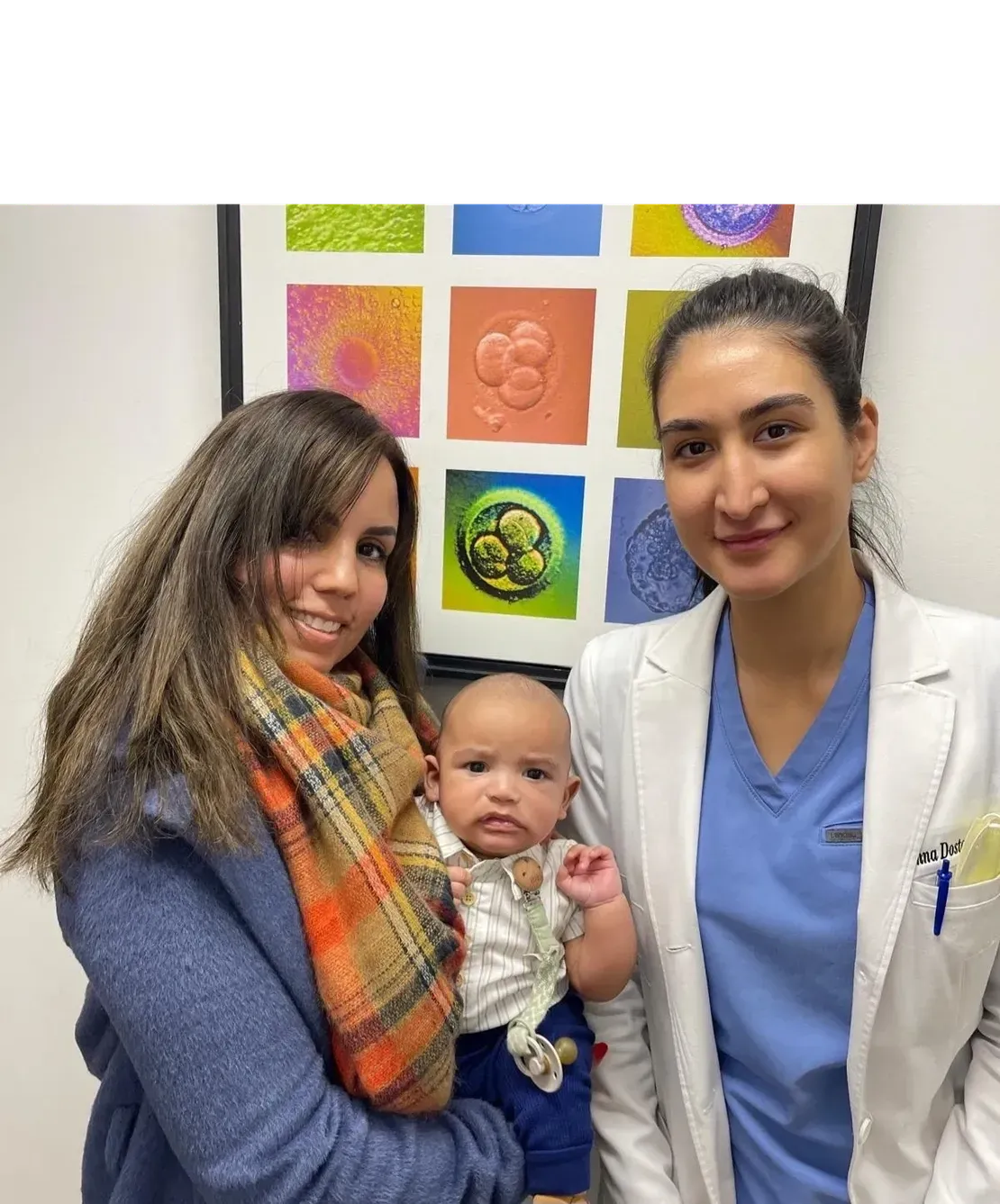 Mother, baby, and doctor smiling together