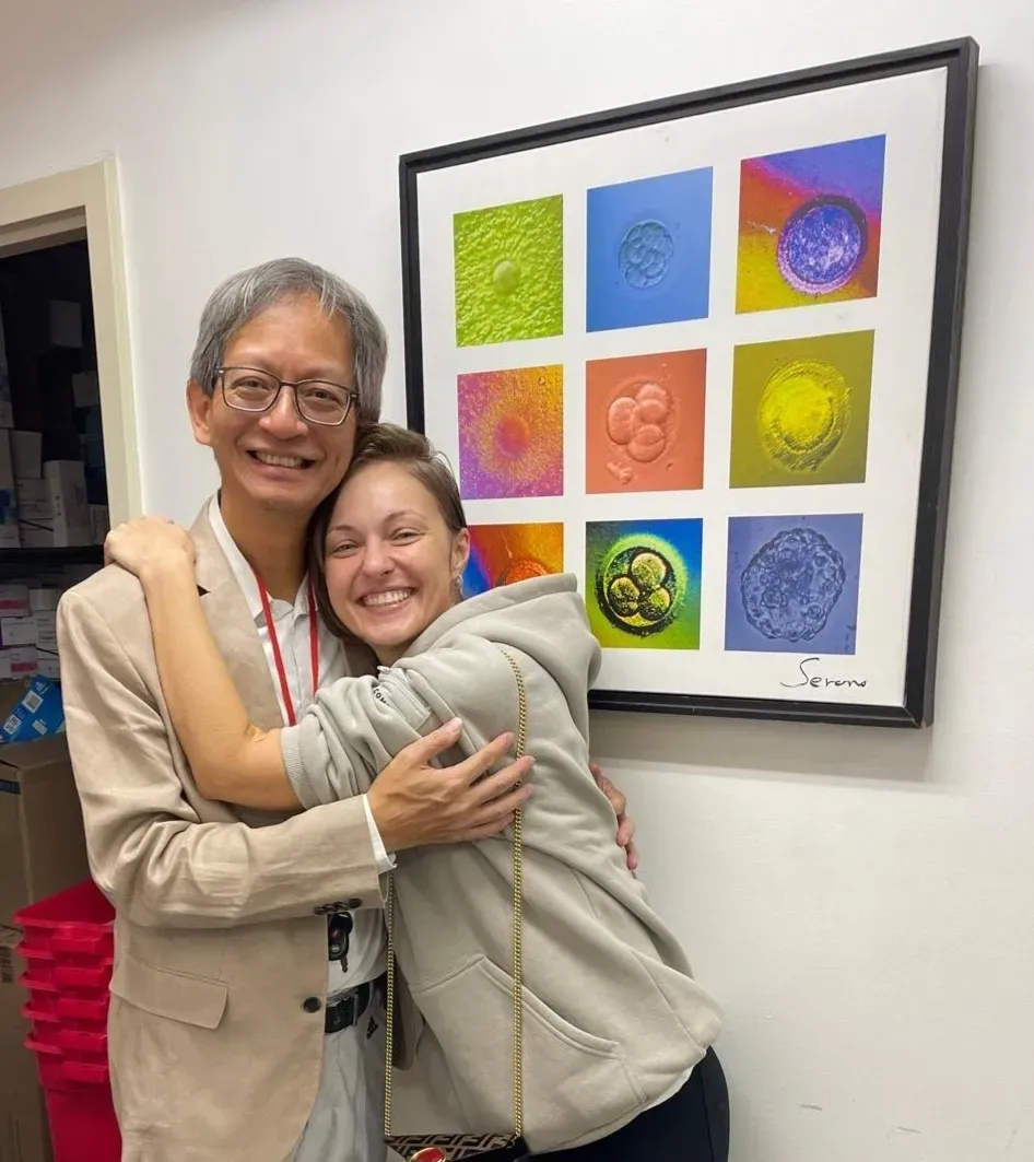 Joyful hug beside framed abstract art