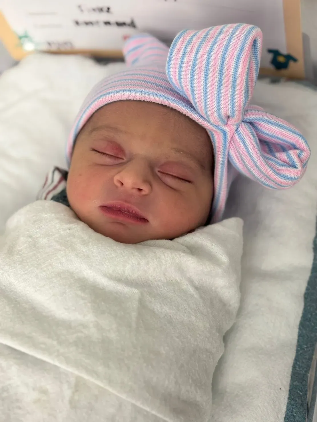Peaceful infant with bow hat