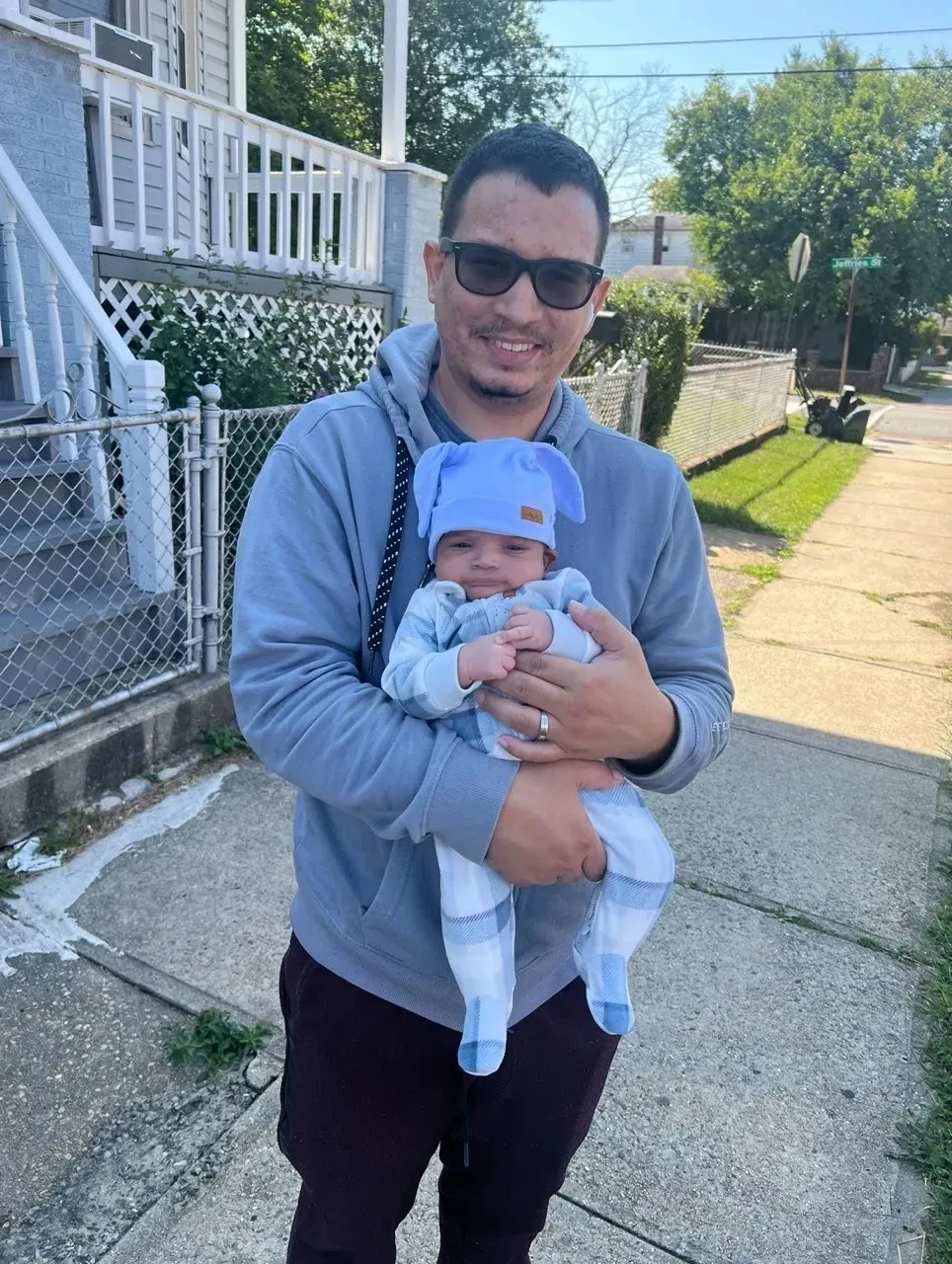 Father and baby on sidewalk