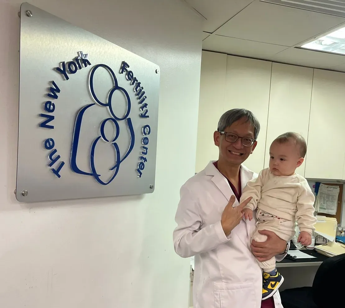 Doctor holding baby at fertility center