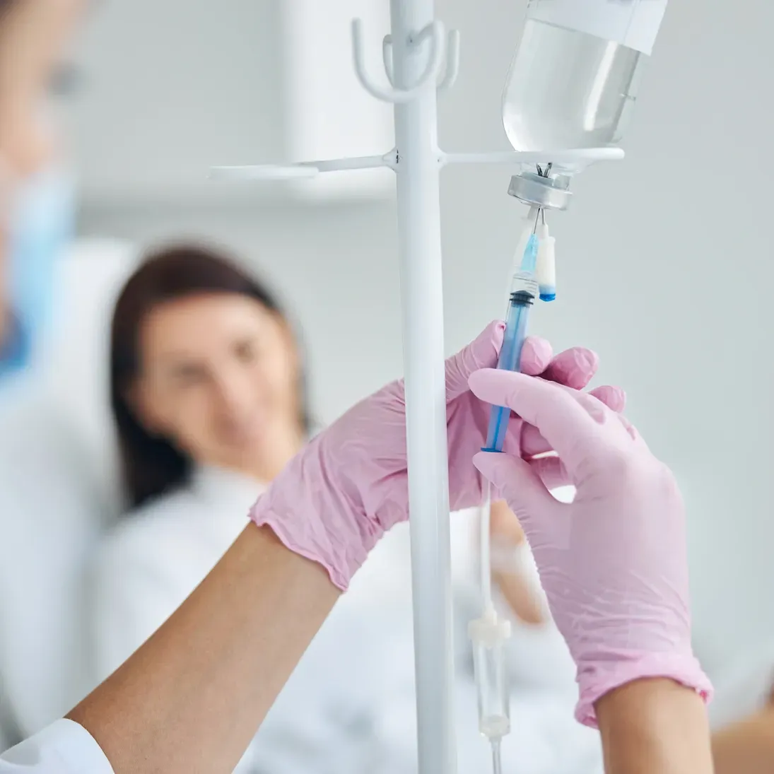 Medical professional handling intravenous equipment