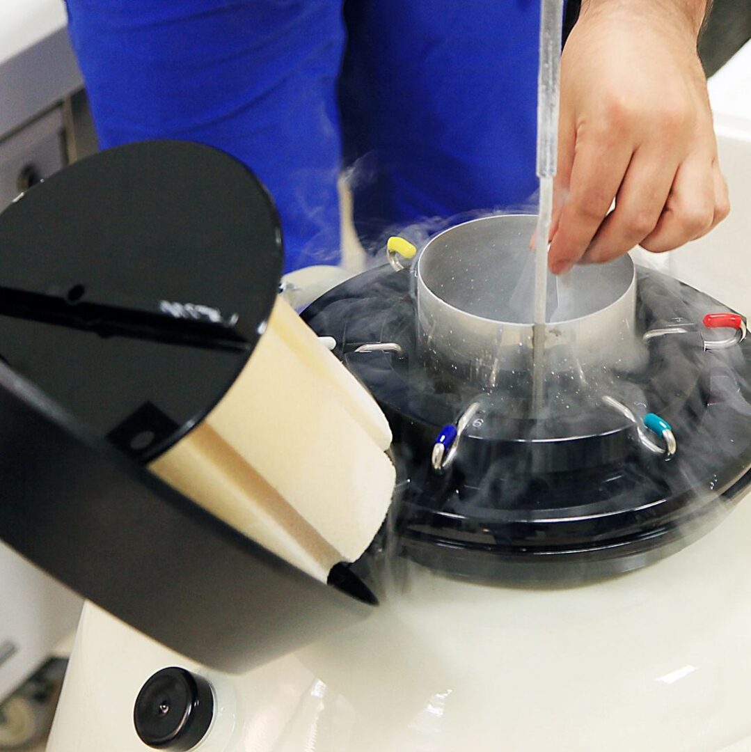 Scientist using cryogenic storage device