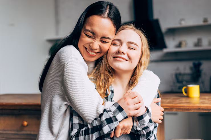 laughing-women-embracing-home_23-2148148030