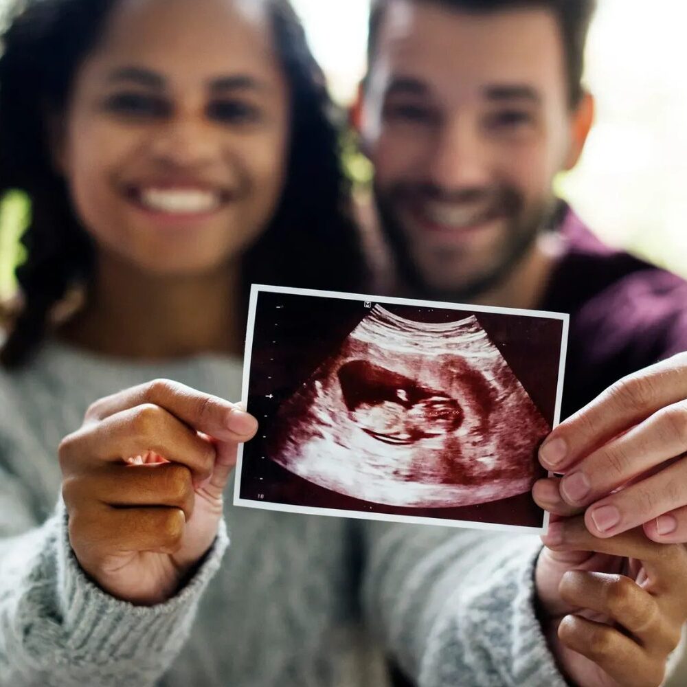 Expectant couple sharing ultrasound picture
