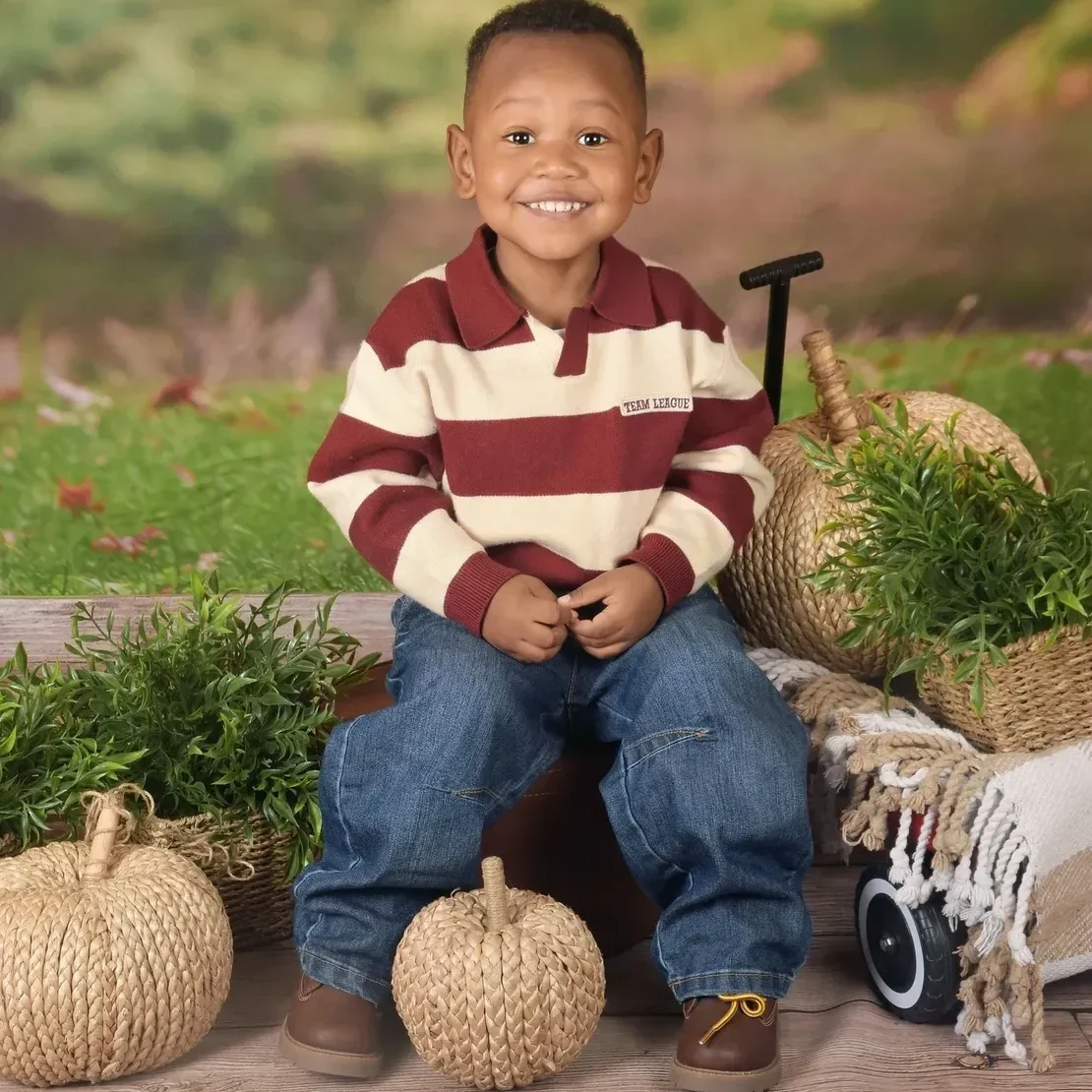 Happy boy in striped sweater outdoors